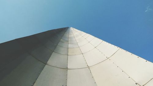 Low angle view of modern building against blue sky