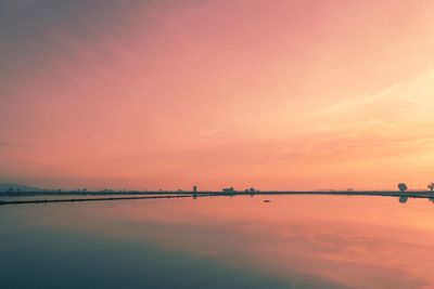 Scenic view of lake against romantic sky at sunset