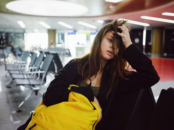 Worried woman sitting at airport