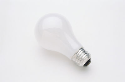 Close-up of light bulb over white background