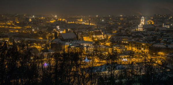 High angle view of illuminated buildings in city at night