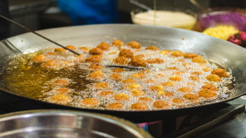 Close-up of food frying in cooking pan