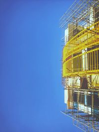 Tilt image of incomplete building against clear sky