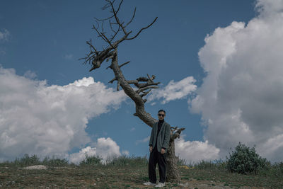 Man standing on field against sky