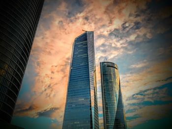 Low angle view of modern buildings against sky during sunset