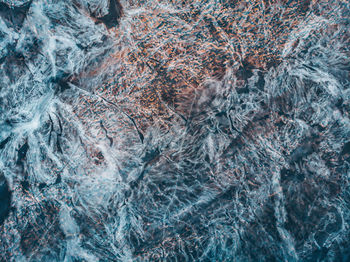 Full frame shot of water flowing through rocks