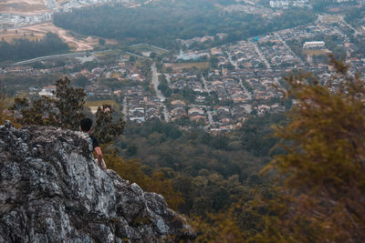 Rear view of man on cliff against sky