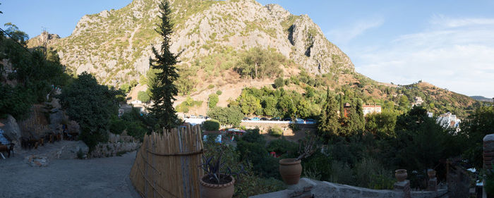 Panoramic view of trees and mountains against sky