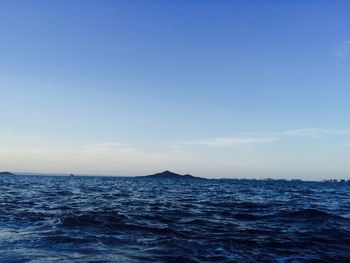 Scenic view of sea against clear blue sky