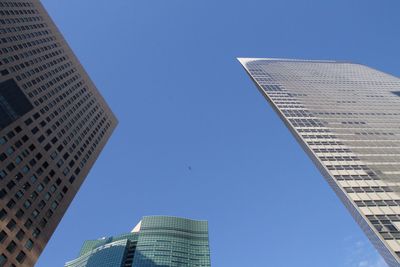 Low angle view of modern buildings against clear blue sky