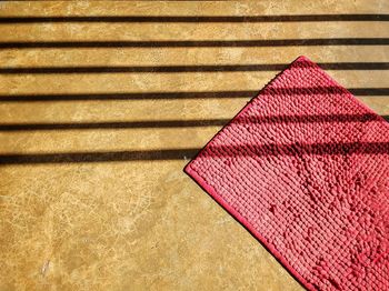 High angle view of pink paper on wood