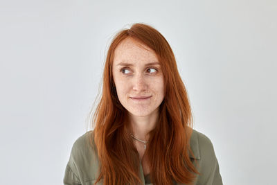 Portrait of smiling woman against white background