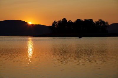 Scenic view of lake against sky during sunset