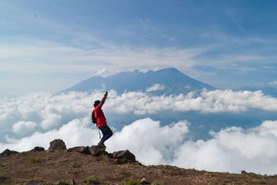 Man standing on mountain against sky