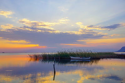 Scenic view of lake against sky during sunset