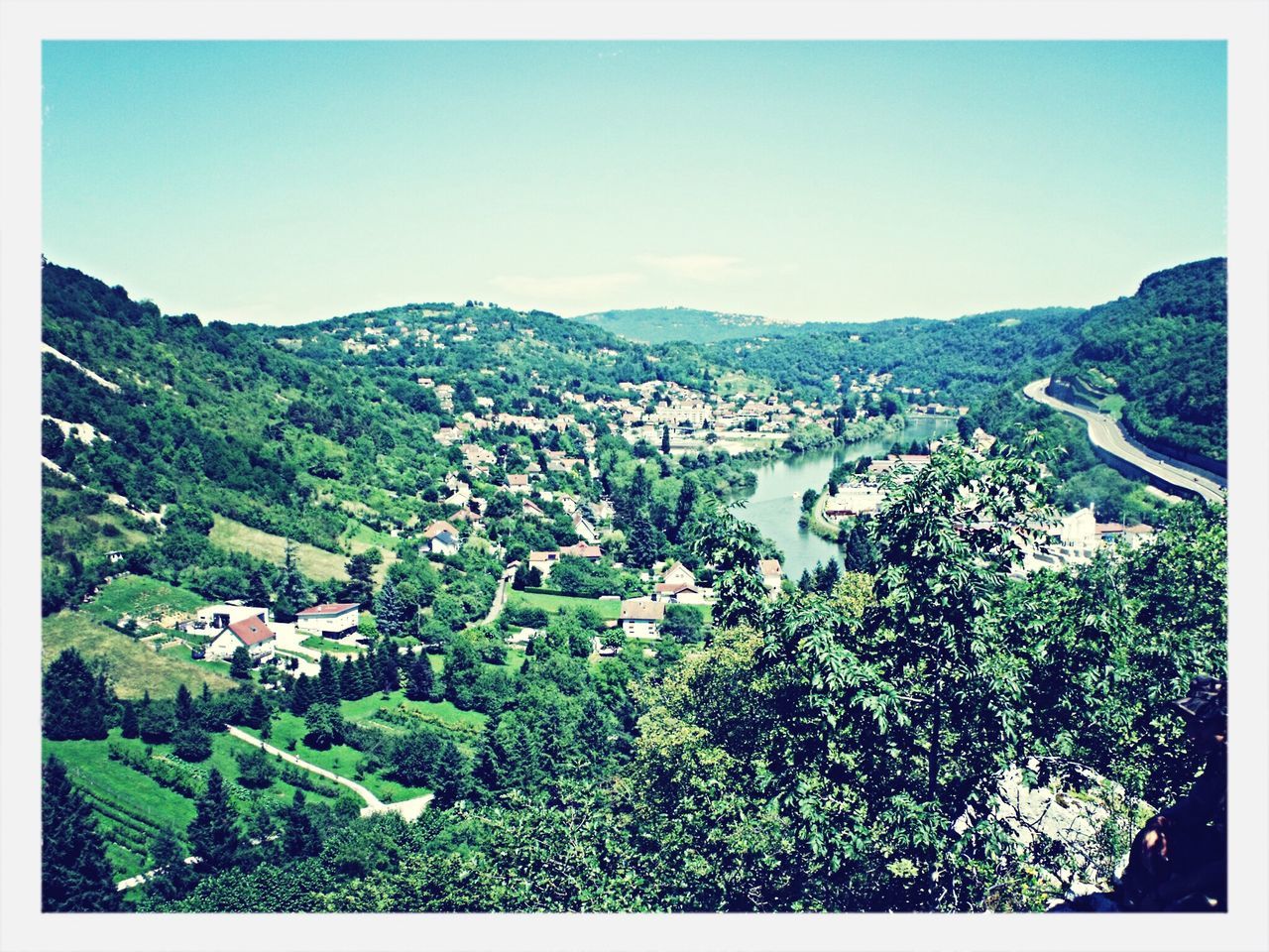 transfer print, mountain, clear sky, auto post production filter, copy space, mountain range, blue, scenics, landscape, beauty in nature, tranquil scene, nature, tranquility, tree, growth, high angle view, hill, green color, plant, building exterior