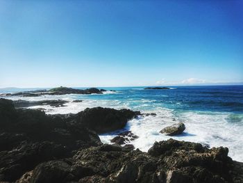 Scenic view of sea against clear blue sky