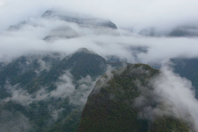 High angle view of fog on mountain against sky
