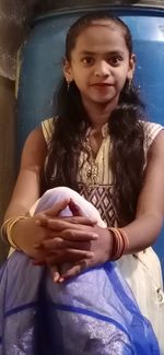 Portrait of smiling girl holding camera