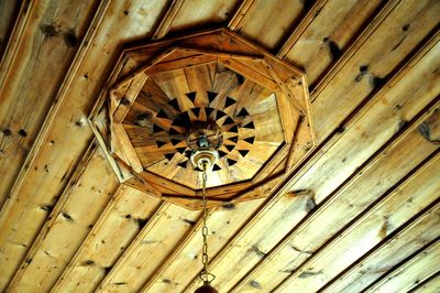 Low angle view of electric lamp hanging on ceiling