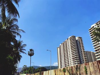 Low angle view of buildings against blue sky