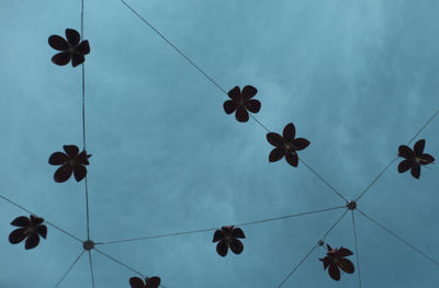 Low angle view of decorations hanging against sky