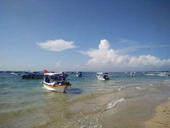 View of boats in calm sea against the sky