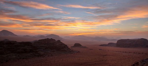 Scenic view of desert against sky during sunset