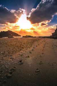 Scenic view of beach against sky during sunset