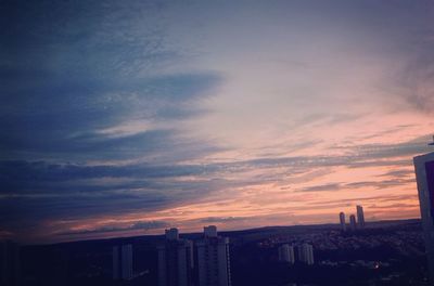 Silhouette buildings against sky during sunset