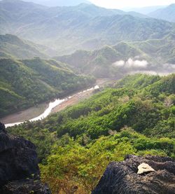 High angle view of green landscape against sky