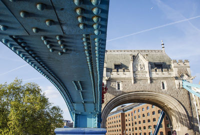 Low angle view of bridge against sky in city