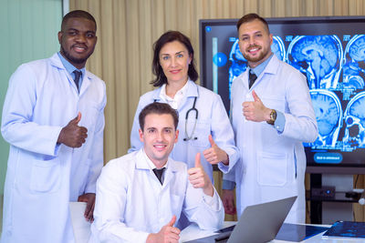 Portrait of female friends standing in hospital