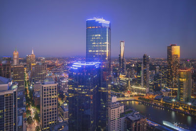 Illuminated cityscape against sky at night