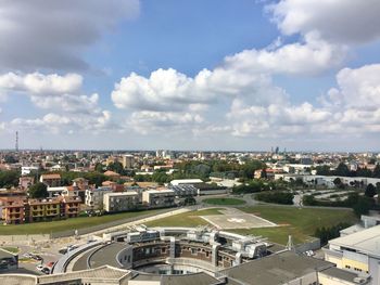 High angle view of buildings in town against sky