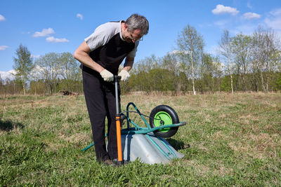 Side view of man working on field
