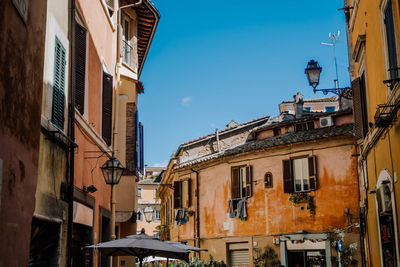 Low angle view of buildings against clear blue sky