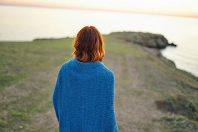 Rear view of woman looking at sea shore