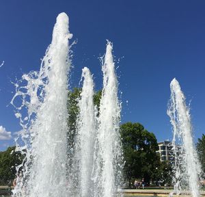 Low angle view of waterfall against sky