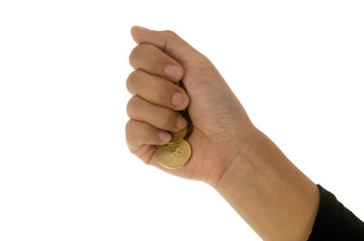 Close-up of hand holding fruit against white background