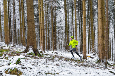 Man walking on snow covered land