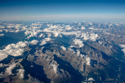 Aerial view of snowcapped mountains against sky