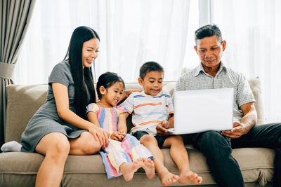 Family using laptop at home