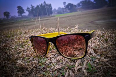 Close-up of sunglasses on field