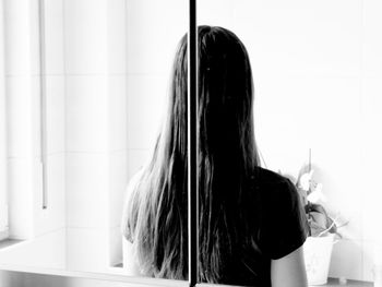 Reflection of woman in mirror at home