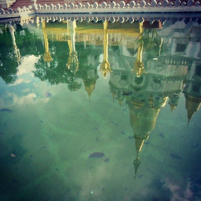 water, reflection, waterfront, built structure, architecture, pond, standing water, puddle, building exterior, lake, high angle view, river, transportation, day, outdoors, wet, nature, mode of transport, canal, no people