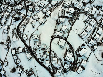 Aerial view of houses and land during winter