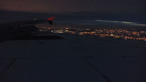 Aerial view of illuminated city against sky