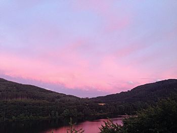 Scenic view of lake against sky at sunset