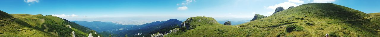 Panoramic view of green landscape against sky